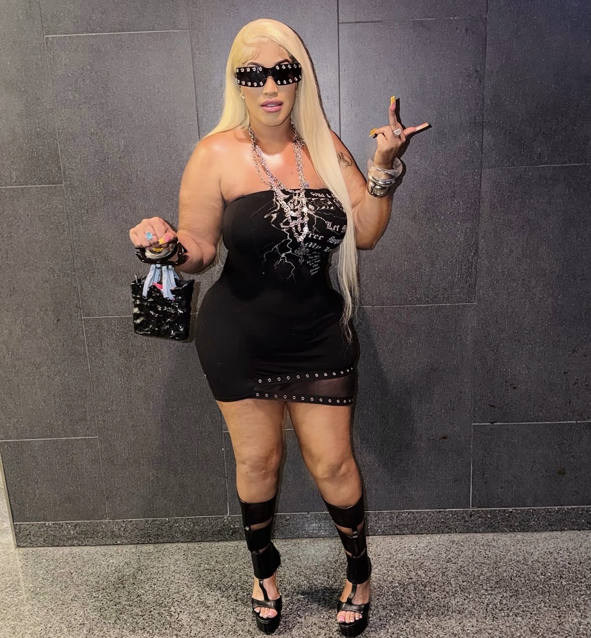 China Chellz wearing sunglasses and a black dress
